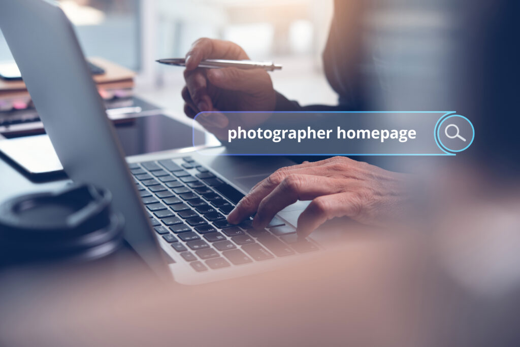 Close up of a Person Working on a Laptop with a Search Bar Overlay That Says photographer Homepage Representing Strategies to Design a High converting Photographer Homepage
