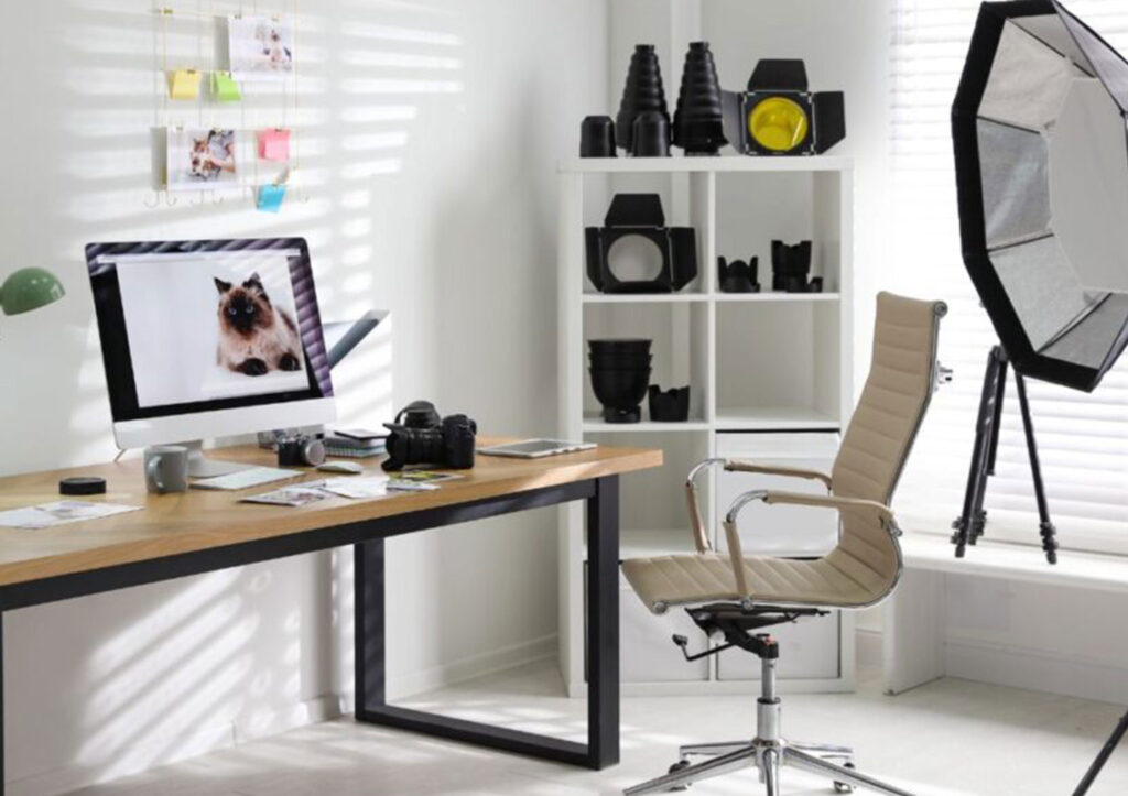 Modern Photography Studio Workspace with Camera Gear Editing Setup and Lighting Equipment Representing a Photography Mastermind Environment