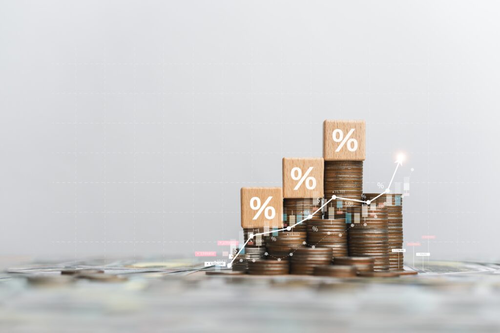 Stacks of Coins with Percentage Blocks and a Rising Graph Representing Profitable Photography Mini Sessions