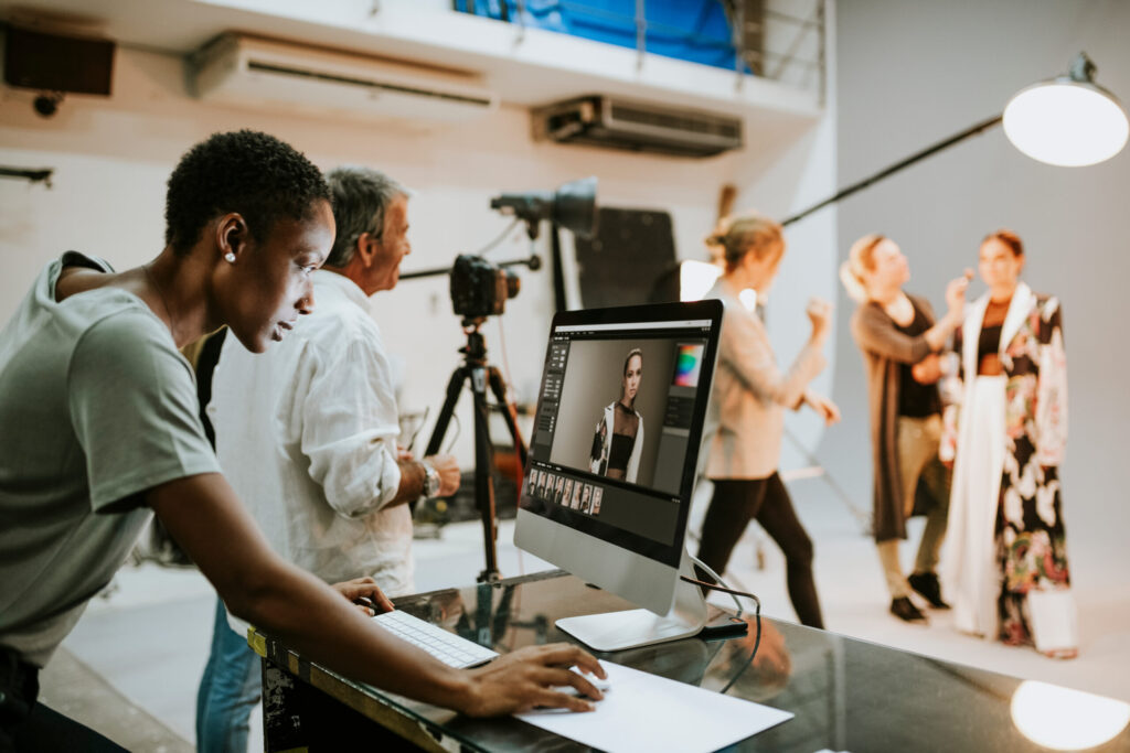 Photographer editing images on a computer during a studio session, representing the discussion around are Google Ads worth it for photographers.
