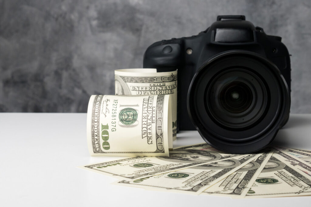Professional Camera with Dollar Bills Symbolizing Business Success Highlighting Why Every Photographer Needs a Mentor to Achieve Financial Growth