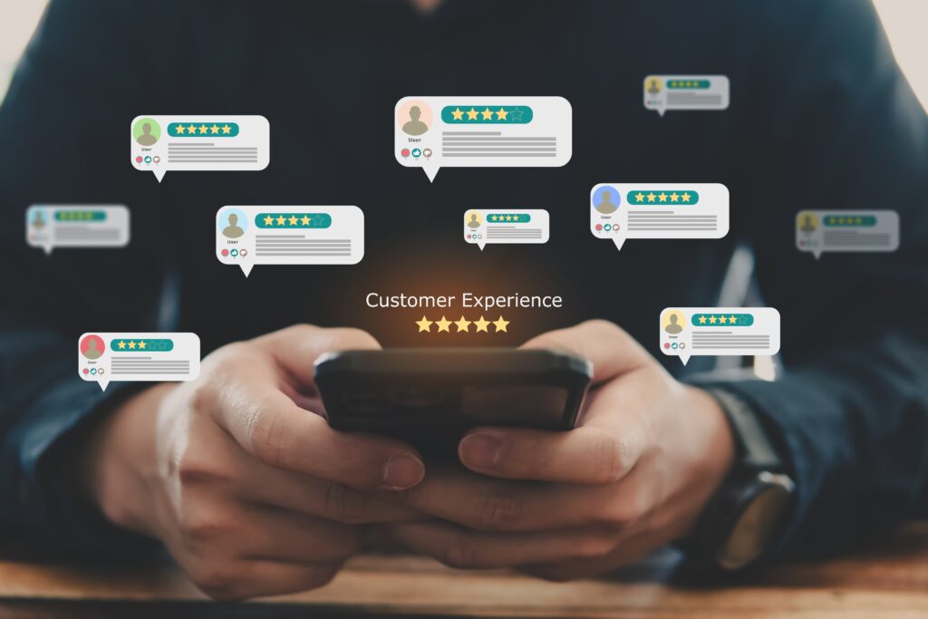 Hands holding a smartphone with floating five-star ratings and feedback icons, representing reviews about photographers and the importance of client testimonials.