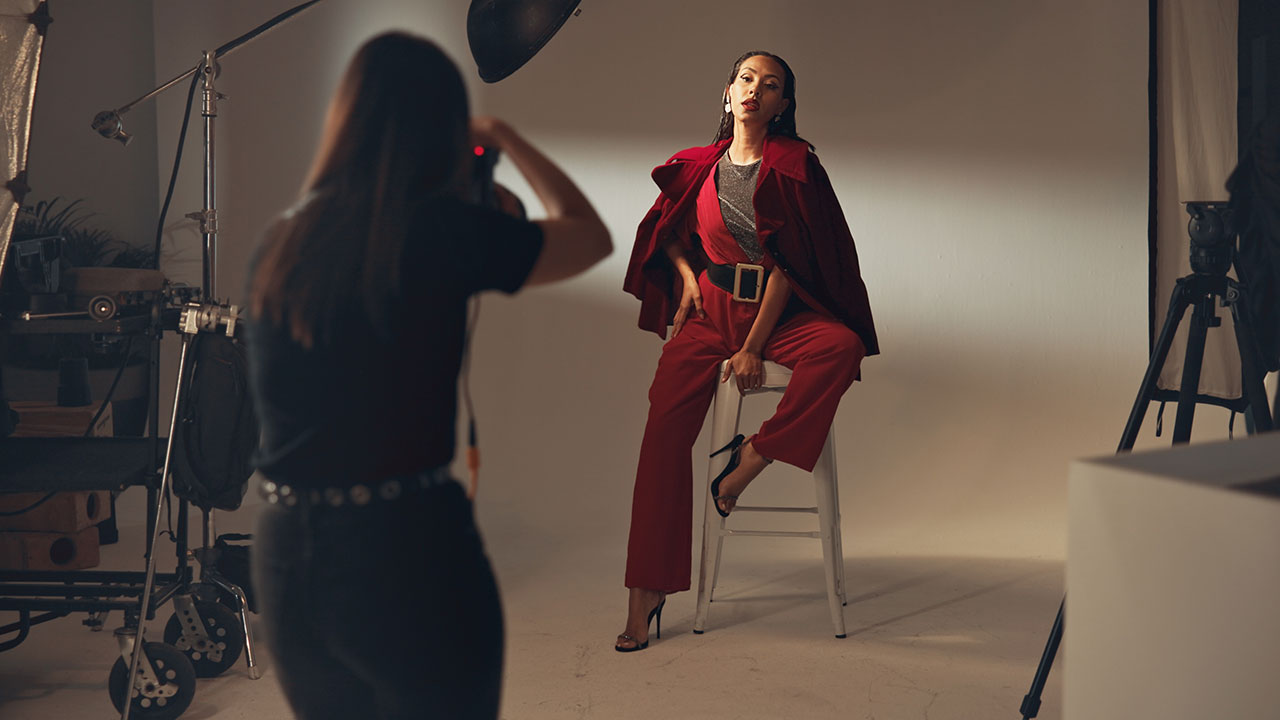 Photographer capturing a luxury fashion portrait session in a professional studio, illustrating the benefits of SEO for luxury photographers to attract high-value clients.