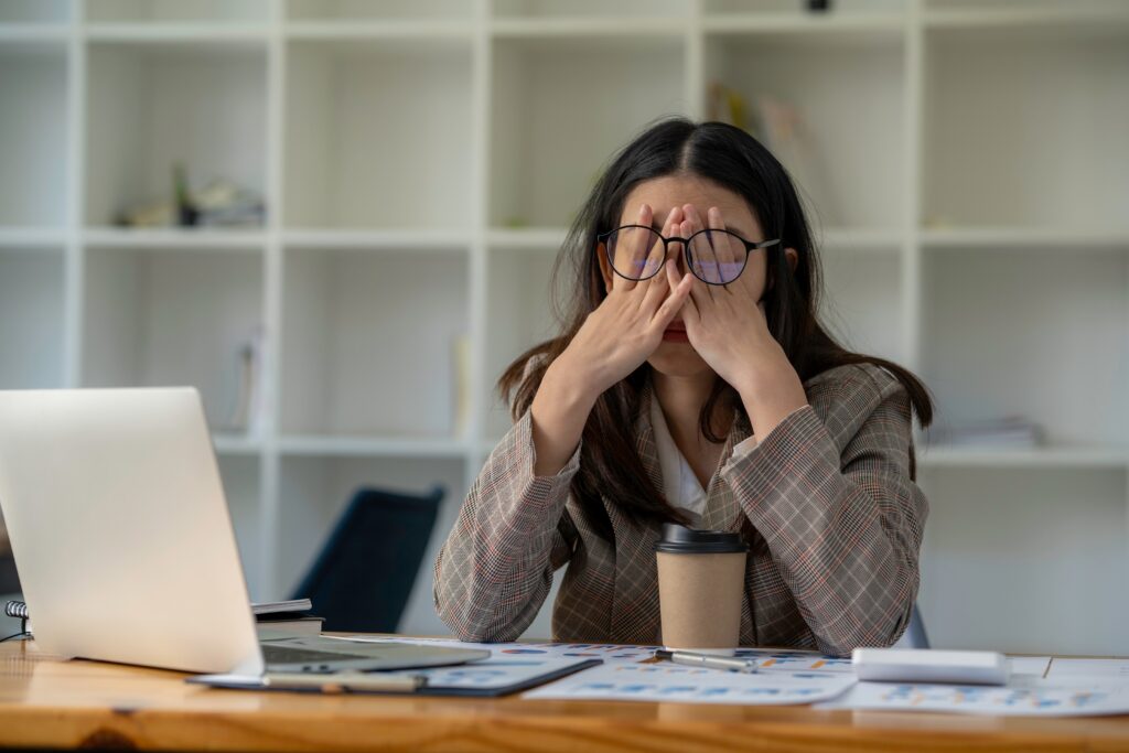 A distressed woman with her hands on her face, symbolizing the challenges addressed by SEO for couples photographers.