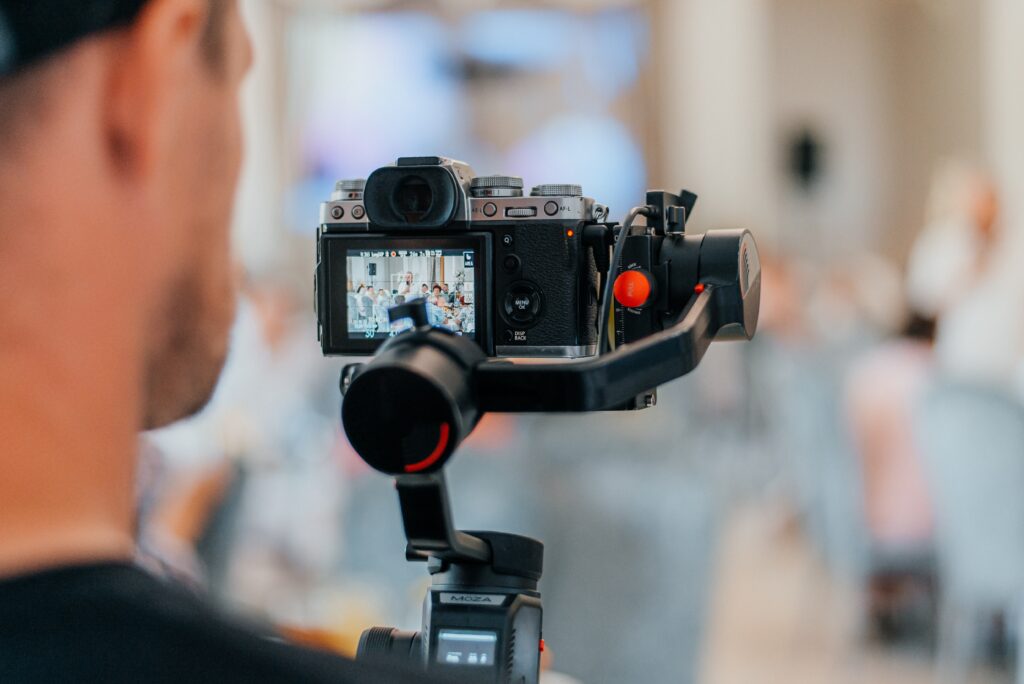 An event photographer capturing a lively wedding scene with a camera, showcasing SEO for event photographers.