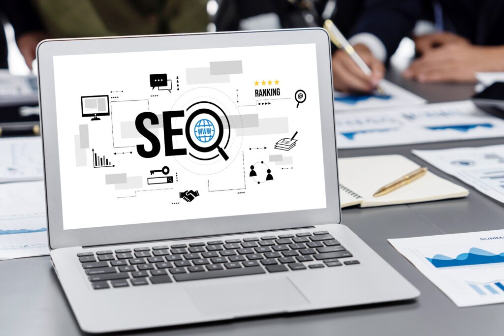Laptop screen showing SEO ranking graphics during a business meeting, symbolizing the question is SEO still worth it for photographers today.
