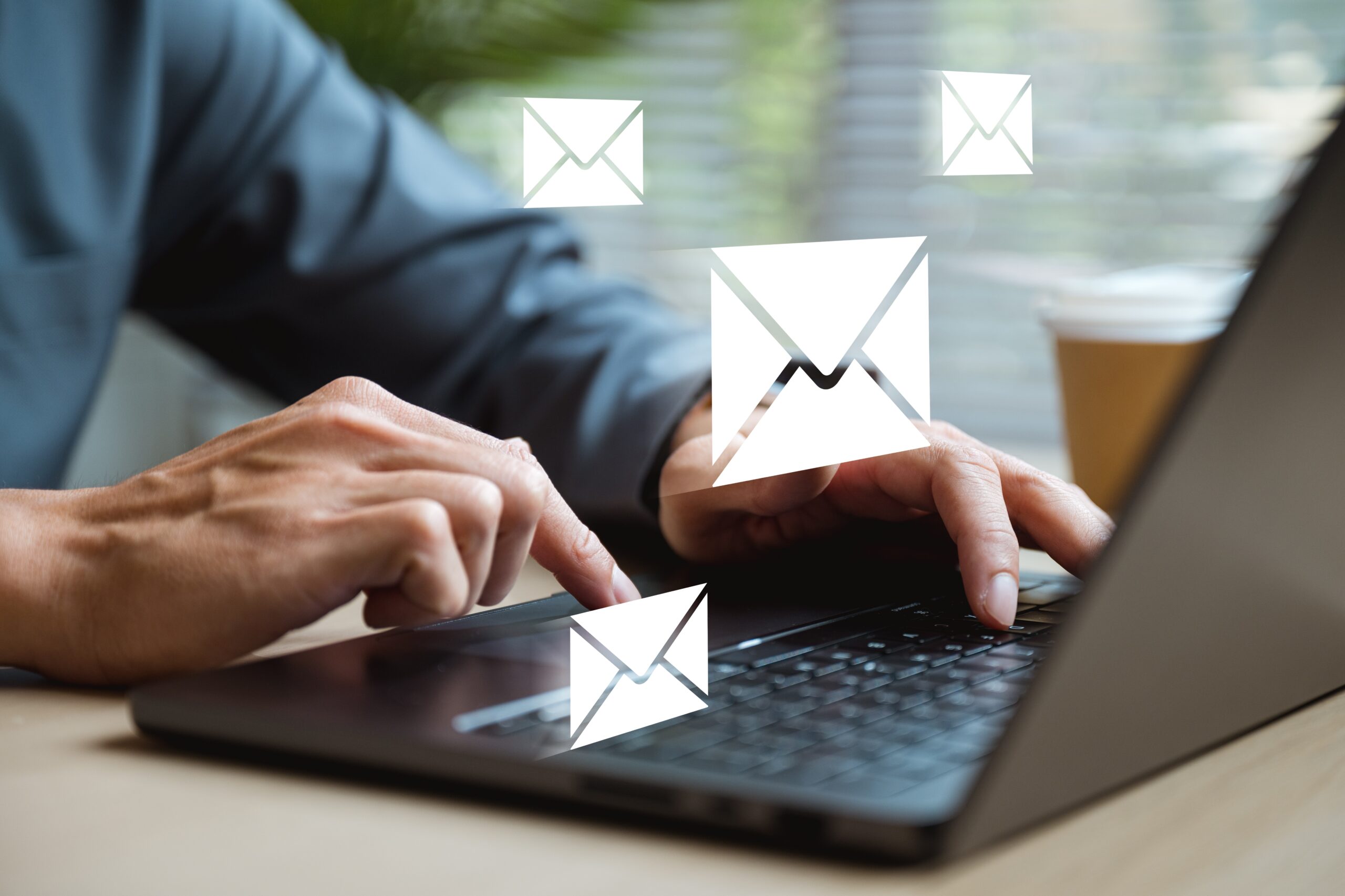 A professional email signature on a laptop screen featuring a photographer's logo and contact details, showcasing email signatures for photographers.