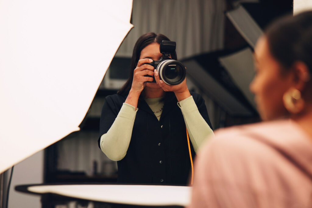 Photographer Taking a Portrait in a Studio with Lighting Setup Representing the Role of Social Media for Photographers in Showcasing Their Work