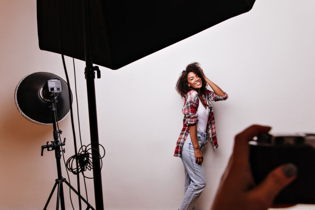 Photographer Capturing a Model Posing in a Studio Demonstrating Content Creation for Social Media for Photographers