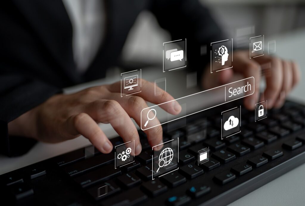 Hands Typing on Keyboard with Digital Search and Marketing Icons Symbolizing Pr and Paid Ads for Photographers