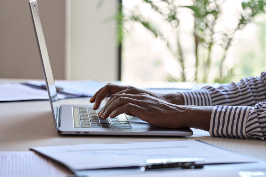 Close up of Hands Typing on a Laptop Representing Local Seo for Photography Websites and Strategies to Increase Online Visibility