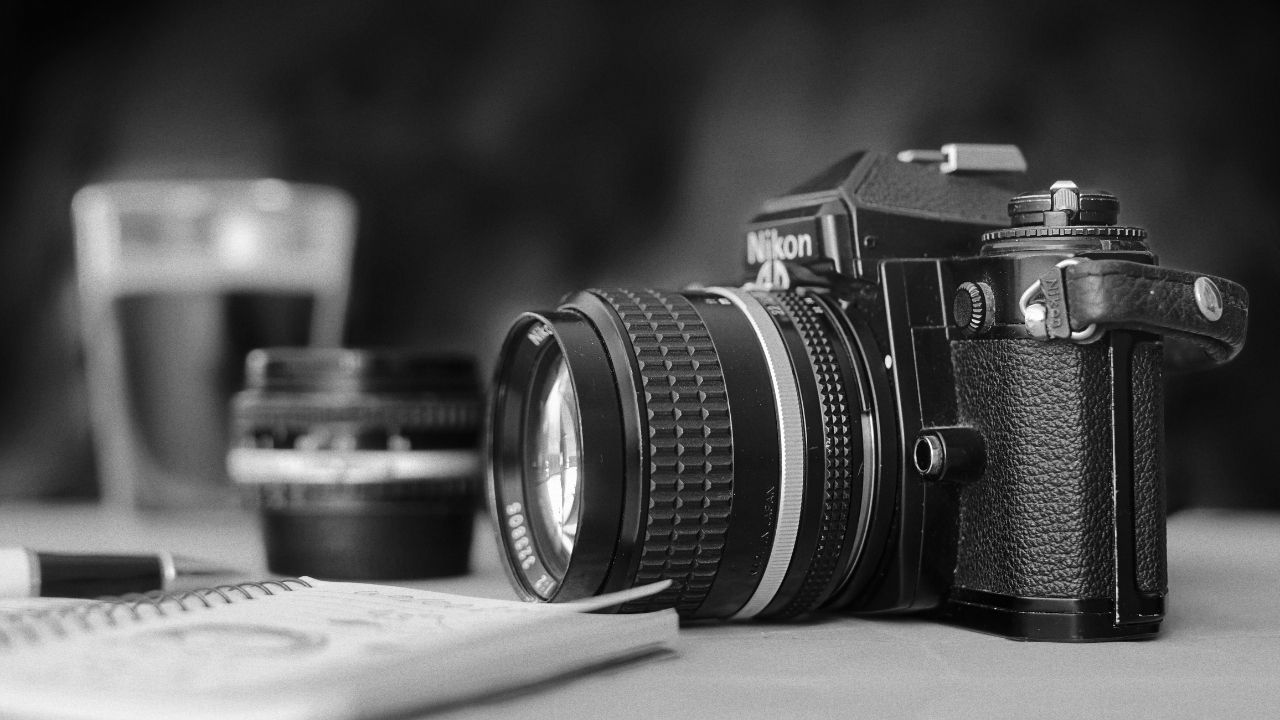 Close-up of a professional camera and notebook, representing strategy and visibility — key themes in How PR and SEO Work Together for photographers.